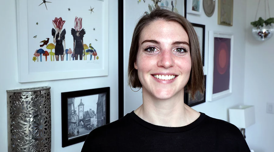 NYC Fair Director, Erin Schuppert, in front of her art collection