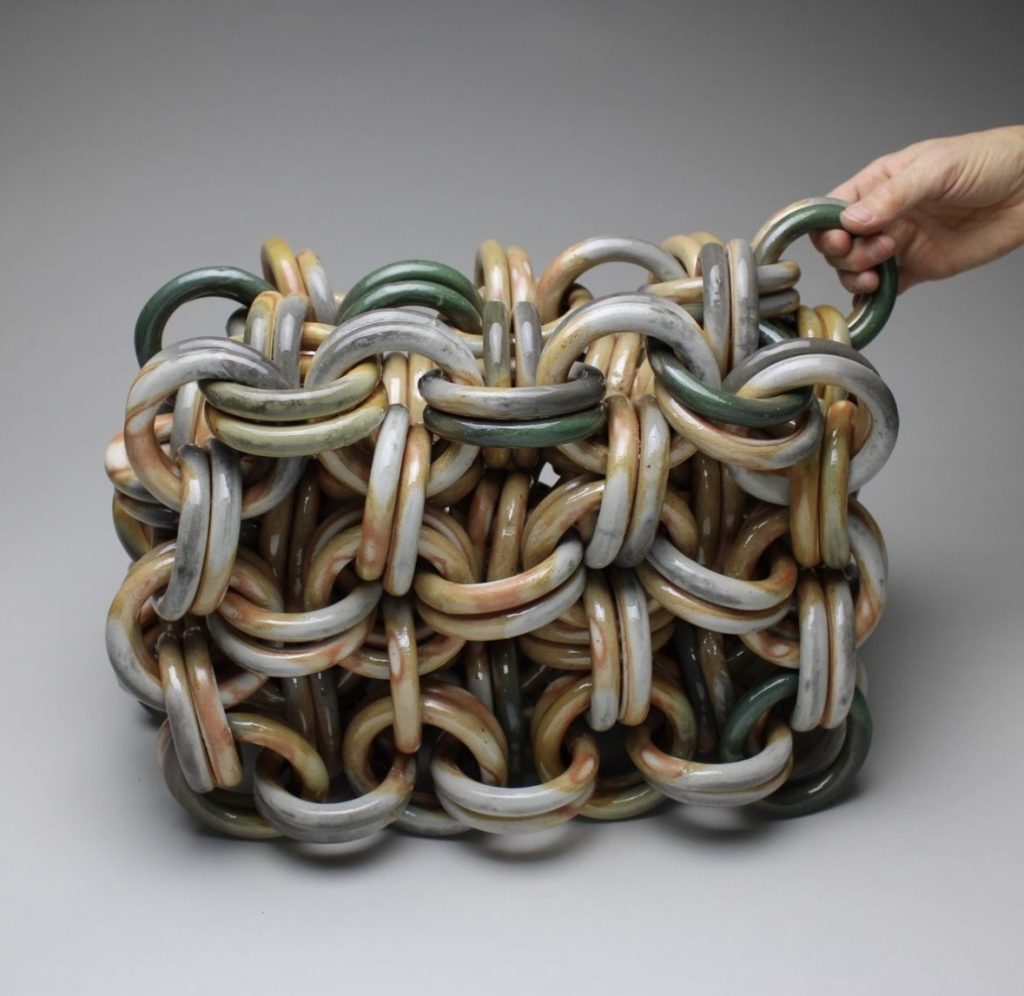 Glazed stoneware that is chained together, with metallic and shiny undertones